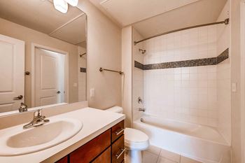 Luxurious bathrooms with abundant storage and mosaic glass tile